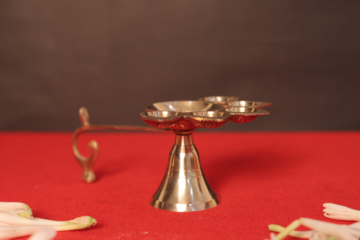 Brass Panchmukhi Aarti Diya, side view showing the handle and pedestal